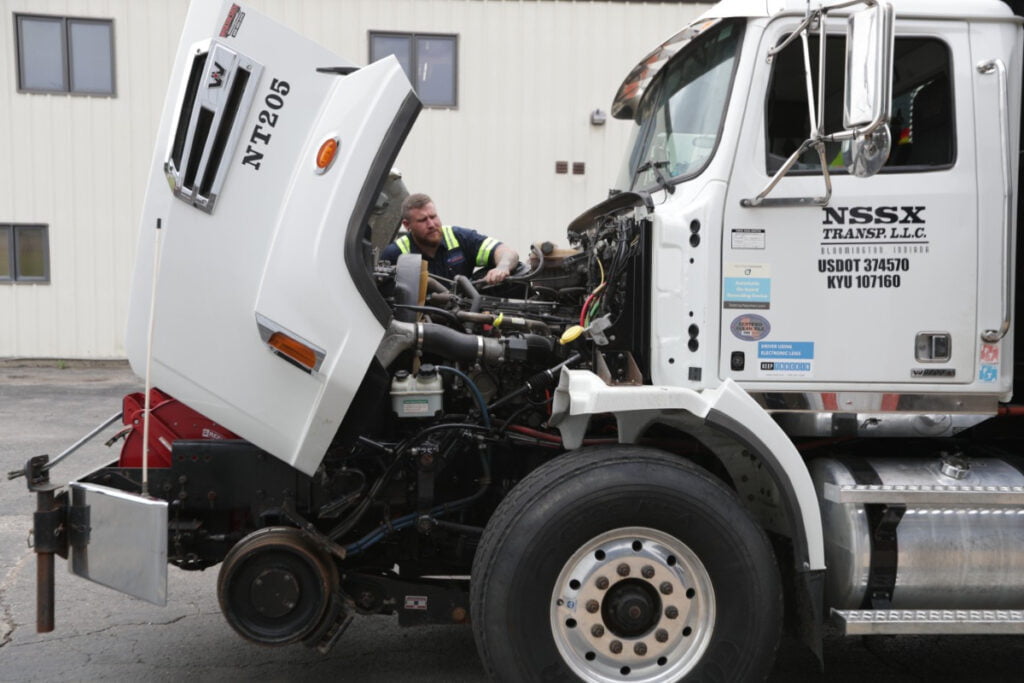 a man working on fleet vehicle