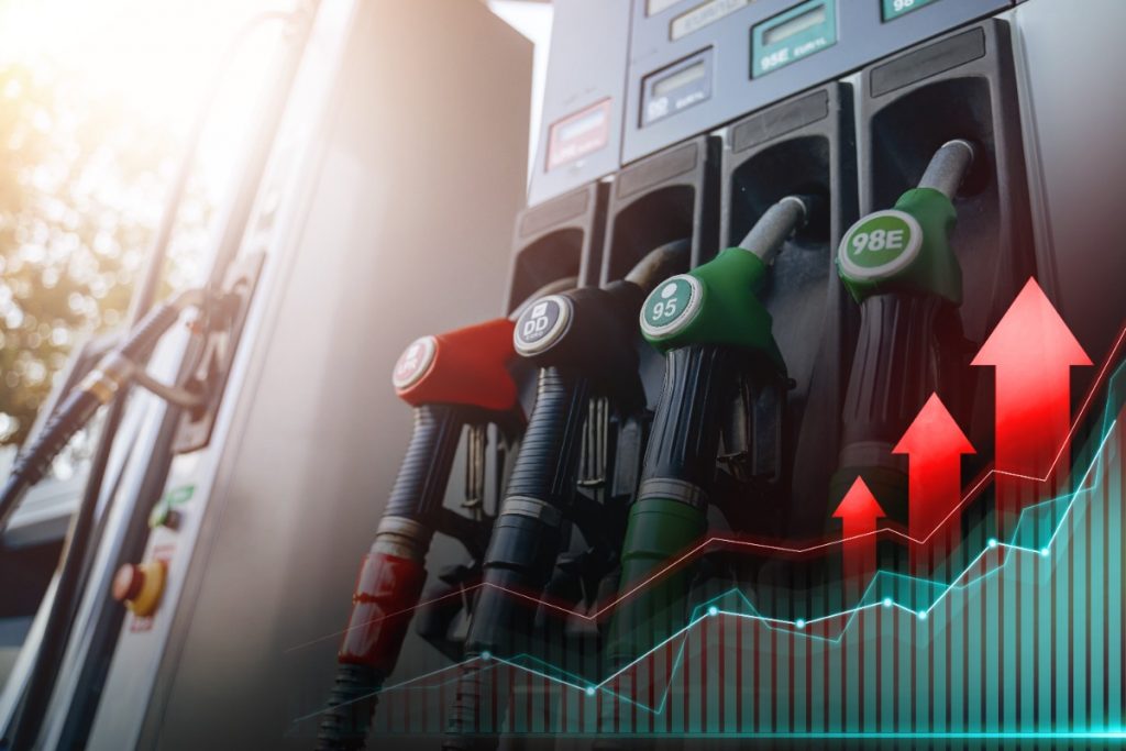 One major heavy-duty truck problem is rising diesel fuel prices. This image shows a gas pump with a graphic overlay depicting arrows and a graph rising.
